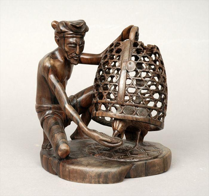 Appraisal: South American Carved Rosewood Figure Group of Man Feeding Cockerel