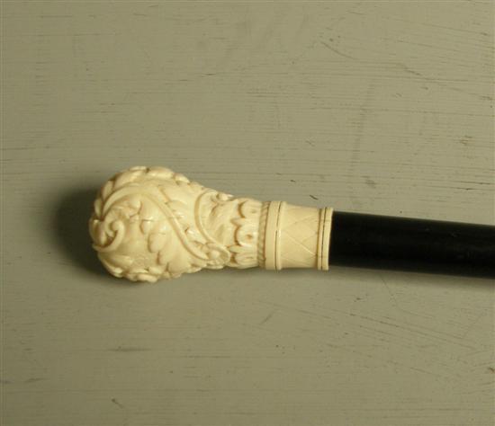 Appraisal: Ebonised walking stick with Indian carved ivory handle the carving