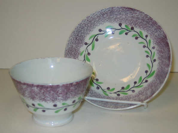 Appraisal: ENGLISH SPATTERWARE Purple spatter berry wreath handless cup and saucer