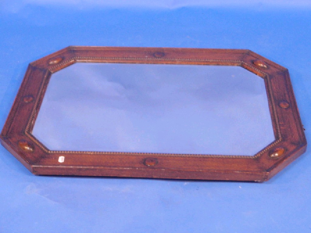 Appraisal: A bevelled oak framed octagonal wall mirror