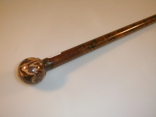 Appraisal: A thC dandy cane with agate pottery ball knop