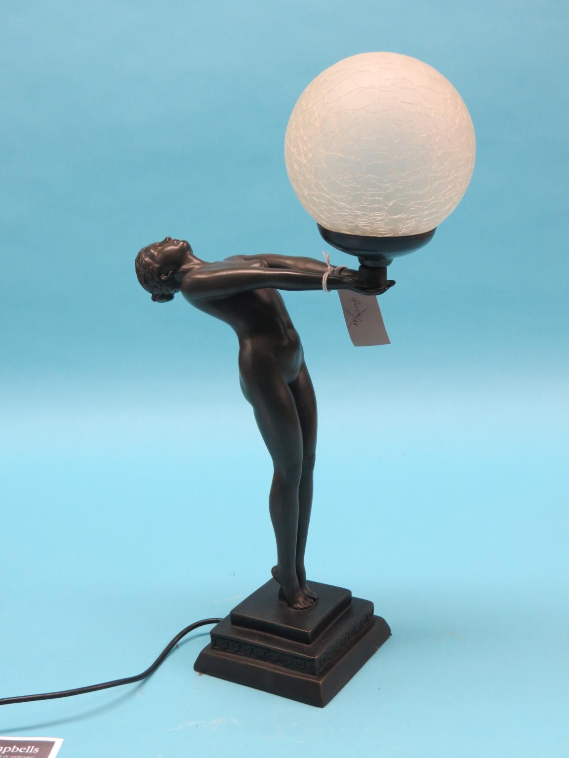 Appraisal: An Art Deco-style bronze-finished table lamp nude female supporting globe