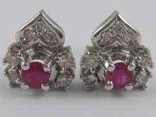 Appraisal: A pair of ruby and diamond stud earrings set in