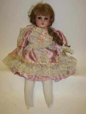 Appraisal: A German bisque shoulder head doll with brown sleeping eyes