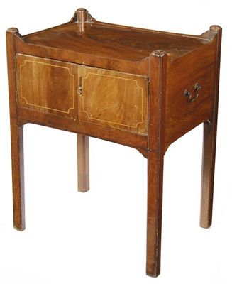 Appraisal: A mahogany bedside cupboard having a pair of line inlaid