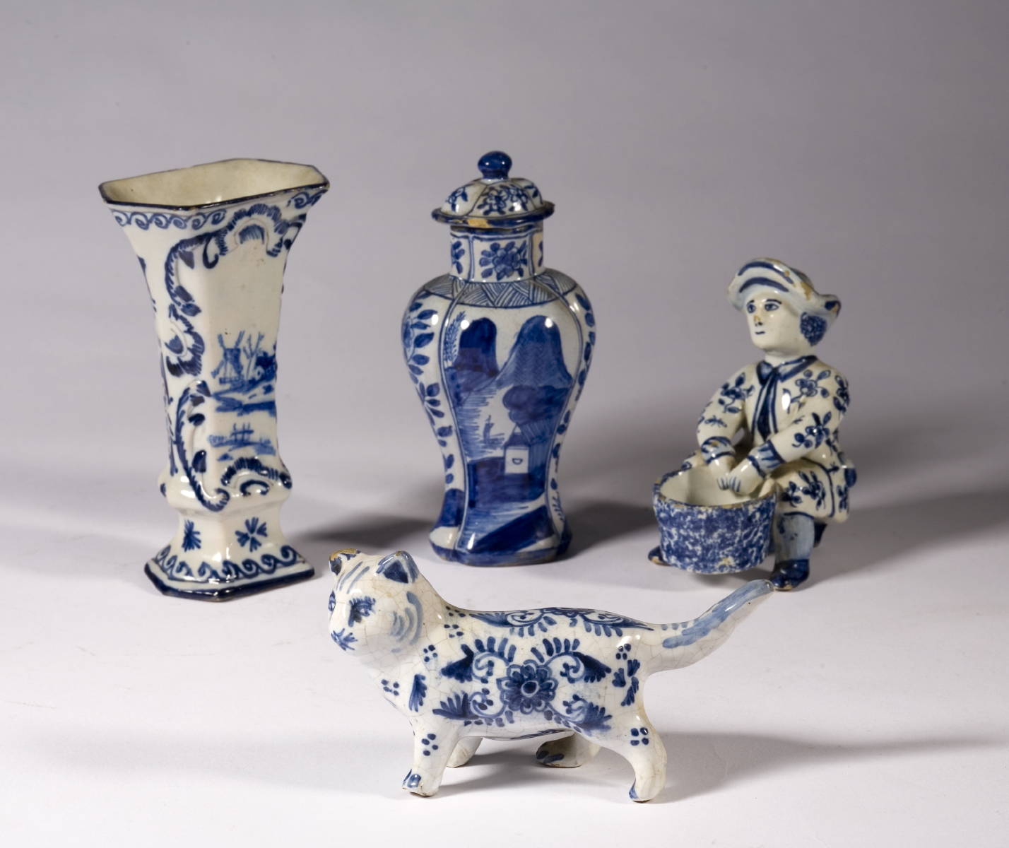 Appraisal: FOUR SMALL DUTCH DELFT BLUE AND WHITE OBJECTS INCLUDING A