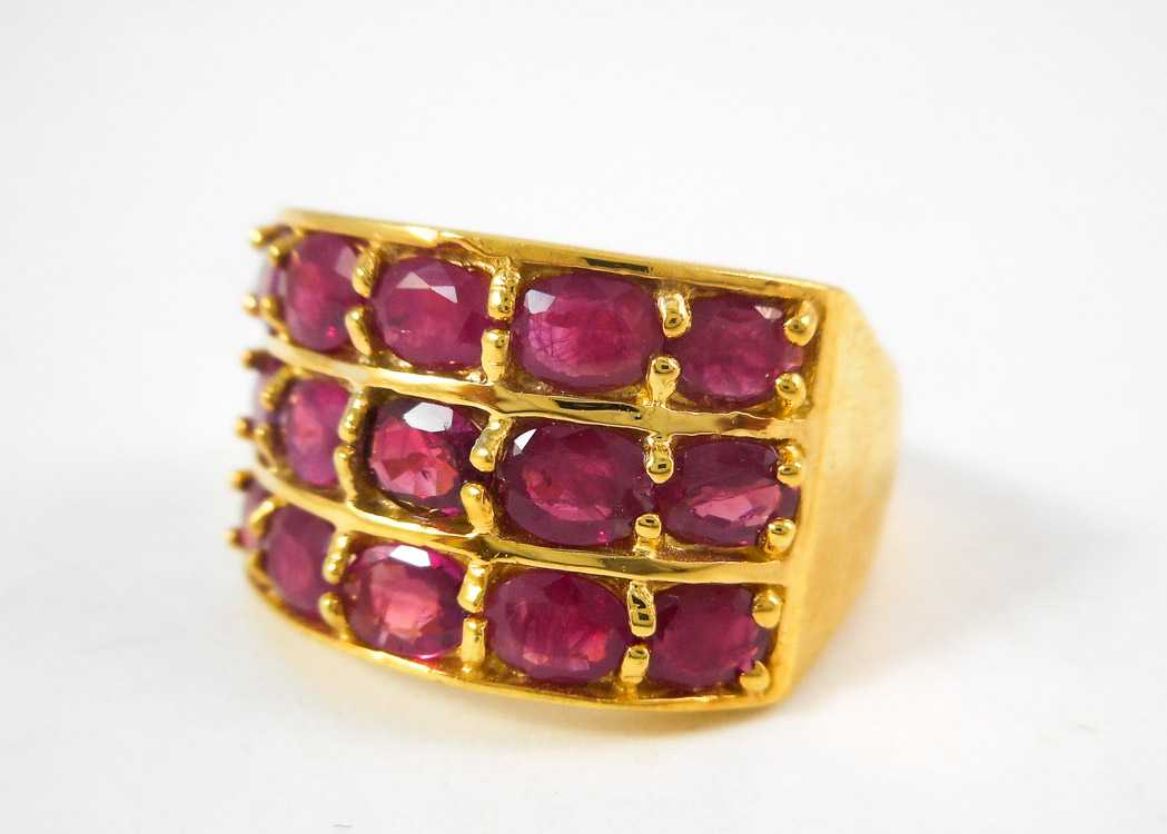 Appraisal: RUBY AND TEN KARAT YELLOW GOLD RING with three rows