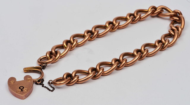 Appraisal: Unmarked yellow metal braceletof chain link form with padlock clasp