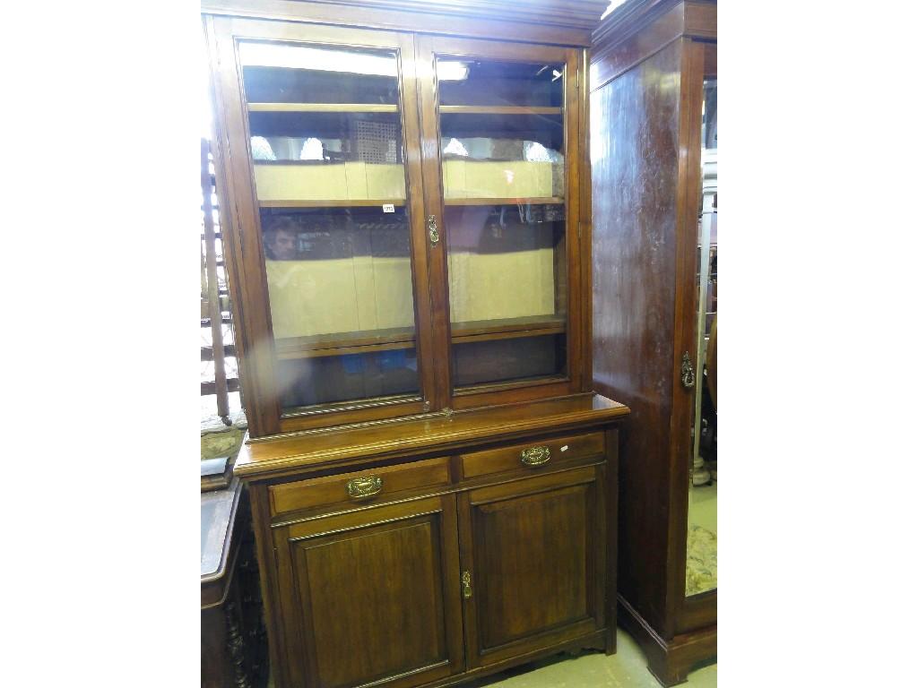 Appraisal: An Edwardian walnut bookcase cupboard the upper section enclosed by