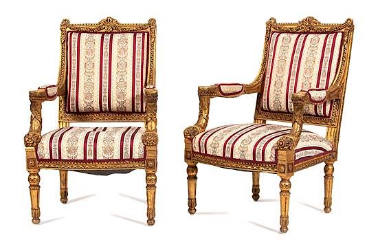 Appraisal: A Pair of Louis XIV Style Carved Giltwood Fauteuils Height