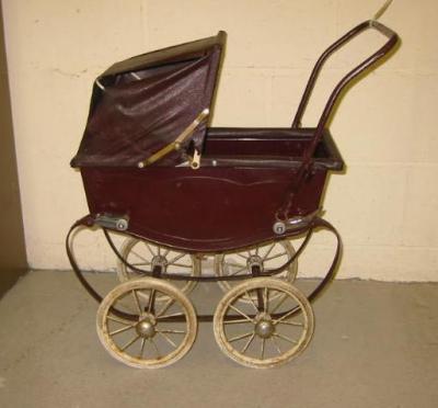 Appraisal: A mid th century Triang dolls pram with maroon painted