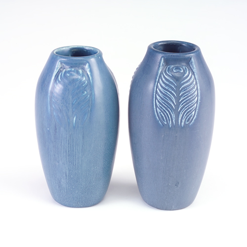 Appraisal: ROOKWOOD Two Production ovoid vases embossed with peacock feathers between