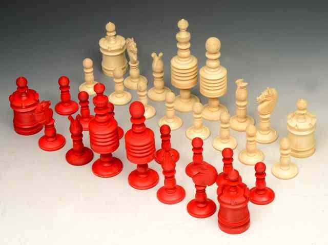 Appraisal: A CARVED IVORY CHESS SET with red and white pieces