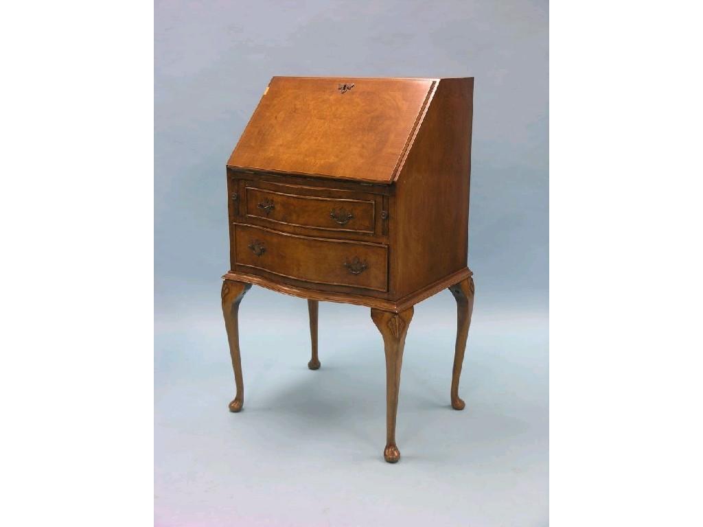 Appraisal: A reproduction burr walnut lady's bureau enclosed fittings above two