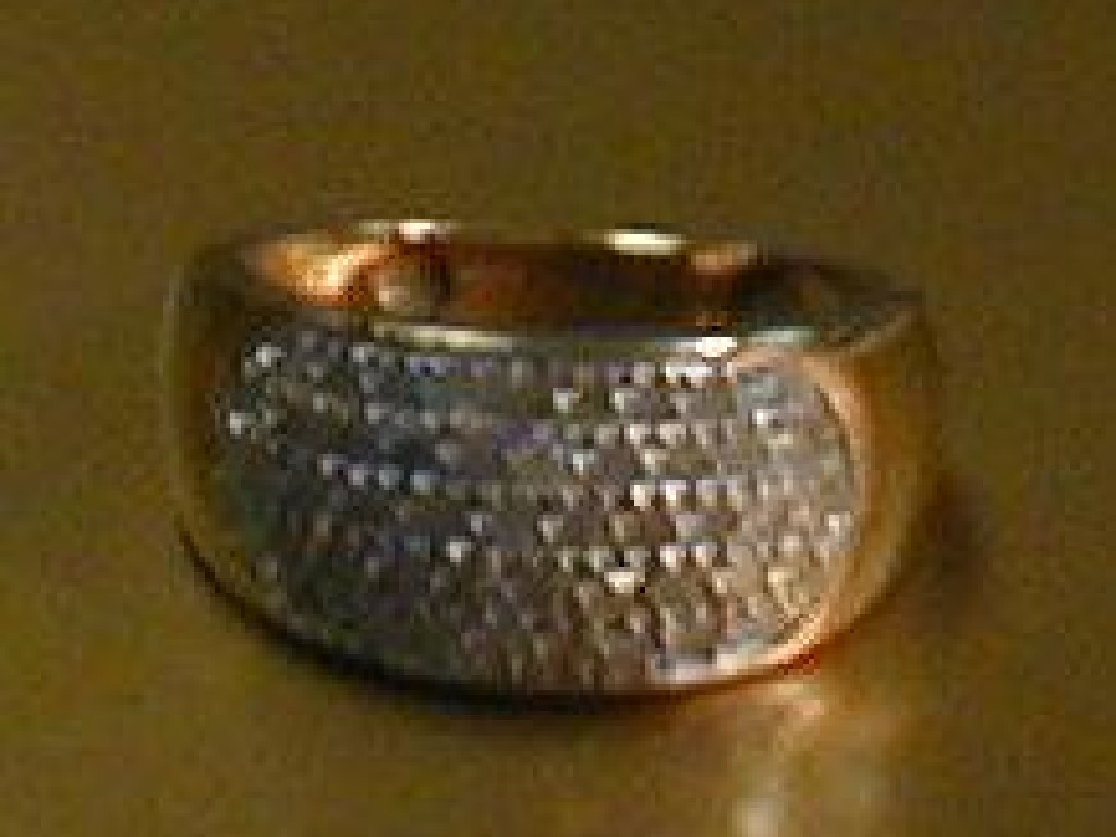 Appraisal: A wide band ring with oval diamond set top to