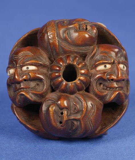 Appraisal: A JAPANESE HARDWOOD NETSUKE in the form of conjoined masks