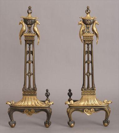 Appraisal: PAIR OF NEOCLASSICAL-STYLE BRONZE AND GILT-METAL ANDIRONS Each vertical pierced