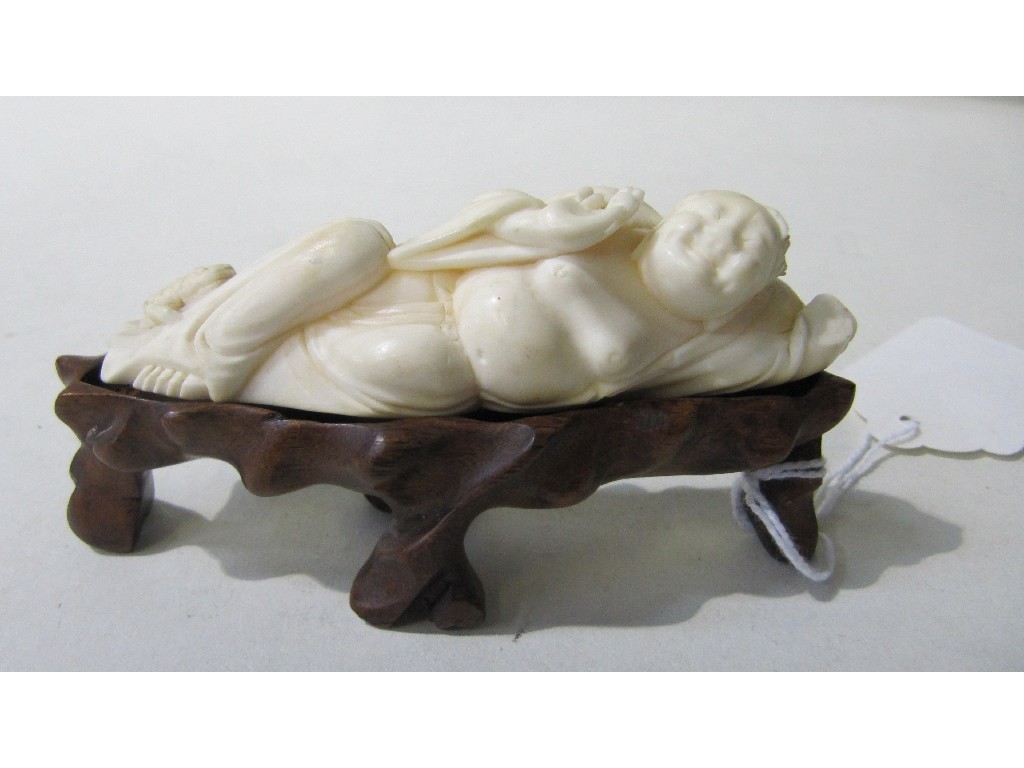 Appraisal: Carved ivory figure - 'Reclining man with toad' on stand