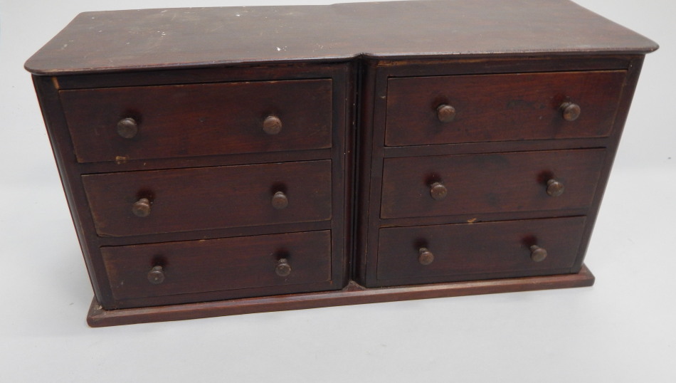 Appraisal: A bank of stained pine collectors drawers each with turned