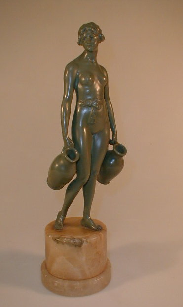 Appraisal: An Art Deco bronzed and onyx-mounted figure of a lady