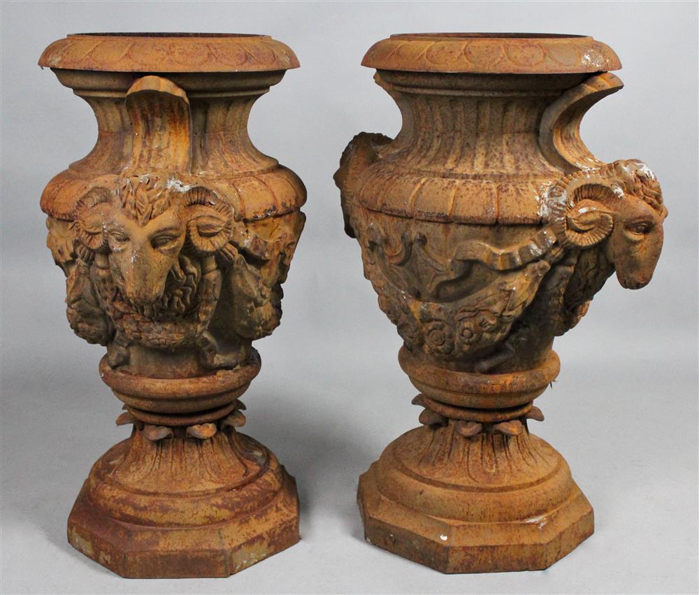 Appraisal: PAIR OF NEOCLASSICAL STYLE CAST IRON URNS with raised mesh