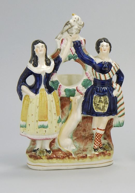 Appraisal: STAFFORDSHIRE POLYCHROME FIGURAL WATCH HOLDER Circa A Scottish couple with