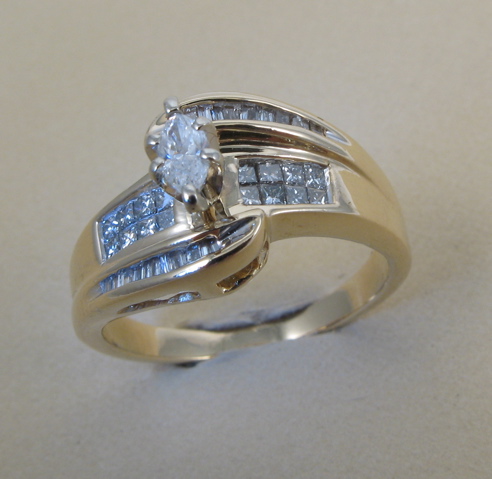 Appraisal: DIAMOND AND FOURTEEN KARAT GOLD RING set with a marquise-cut