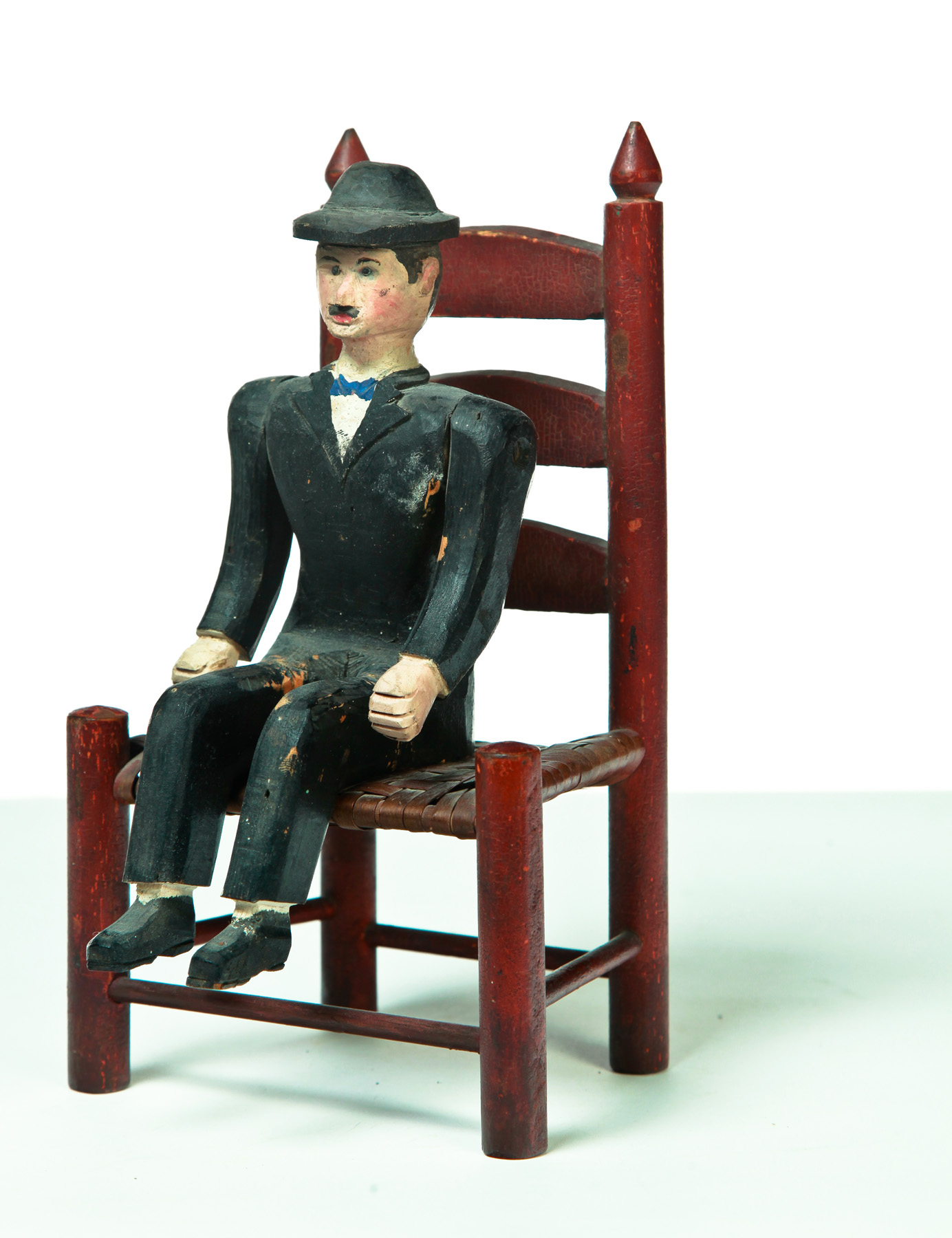 Appraisal: AMERICAN DOLL'S CHAIR AND CARVING OF A MAN Eary th