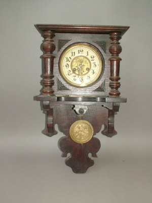 Appraisal: A Continental wooden cased wall clock the case of architectural