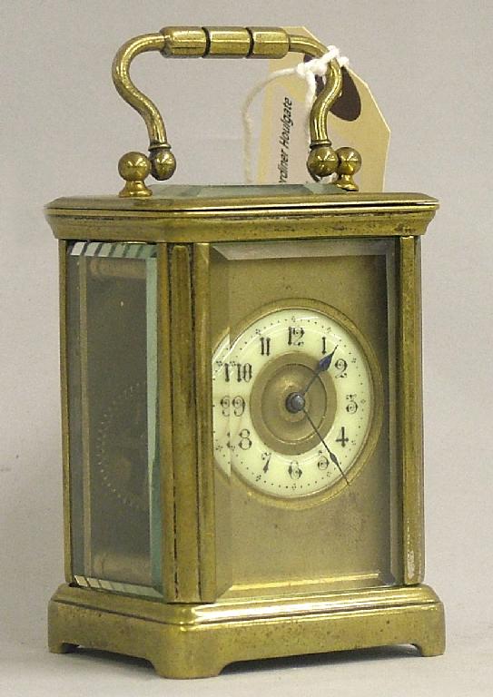 Appraisal: Miniature brass carriage timepiece the cream chapter ring within a