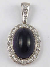 Appraisal: A white metal tests carat gold amethyst and diamond pendant