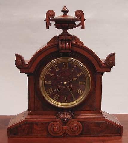 Appraisal: Walnut and burl walnut carved case with urn finial eight-day