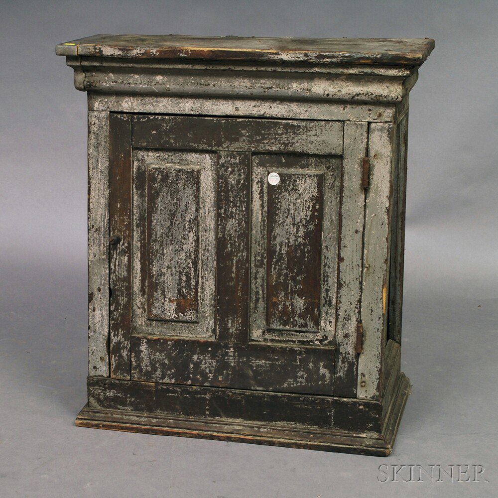 Appraisal: Gray-painted Canted Cupboard th century the double-paneled door opening to