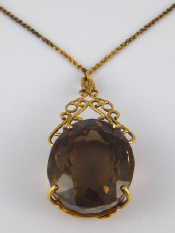 Appraisal: A yellow metal tests carat gold smoky quartz pendant the