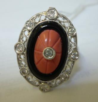 Appraisal: AN ART DECO STYLE DRESS RING the central domed oval