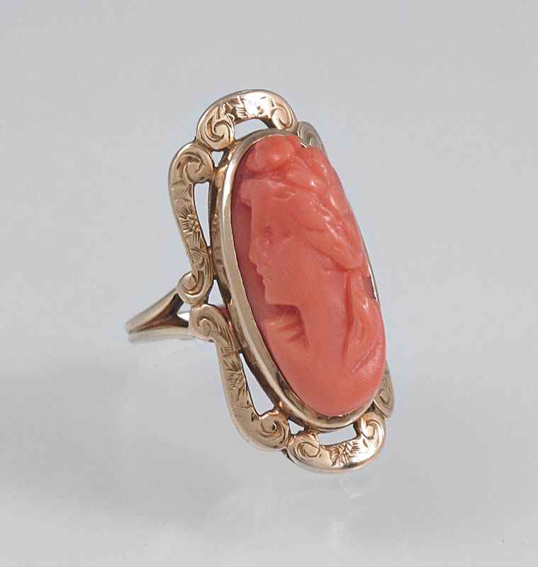 Appraisal: CARVED CORAL CAMEO RING K yellow gold ring with oval