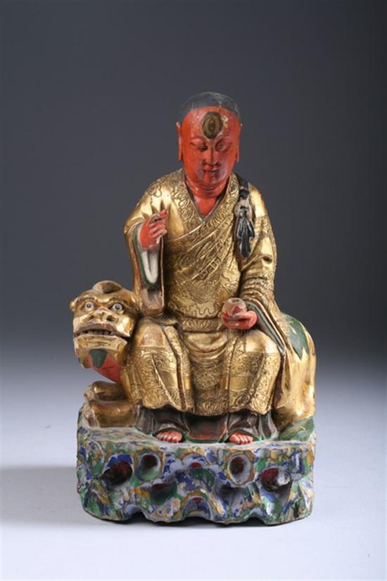 Appraisal: CHINESE POLYCHROME WOOD FIGURE OF IMMORTAL AND FU LION Seated