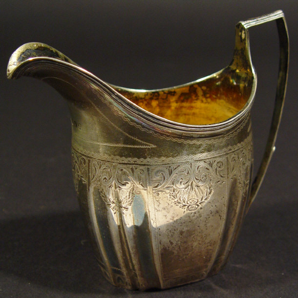 Appraisal: Georgian silver cream jug of fluted form with chased decoration