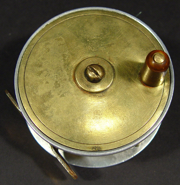 Appraisal: Brass fishing reel with turned wooden handle cm diameter