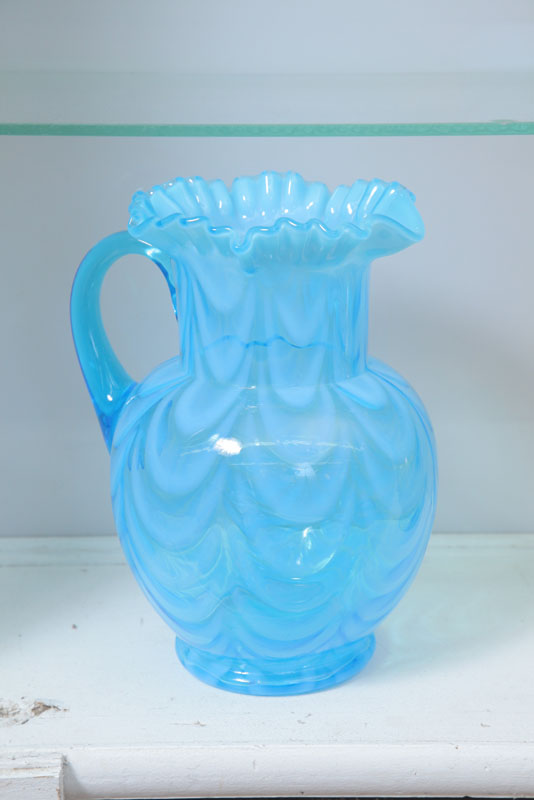 Appraisal: ART GLASS PITCHER In blue Opalescent drape with ruffled rim