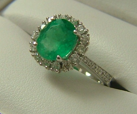 Appraisal: EMERALD DIAMOND AND EIGHTEEN KARAT GOLD RING centering an oval-cut