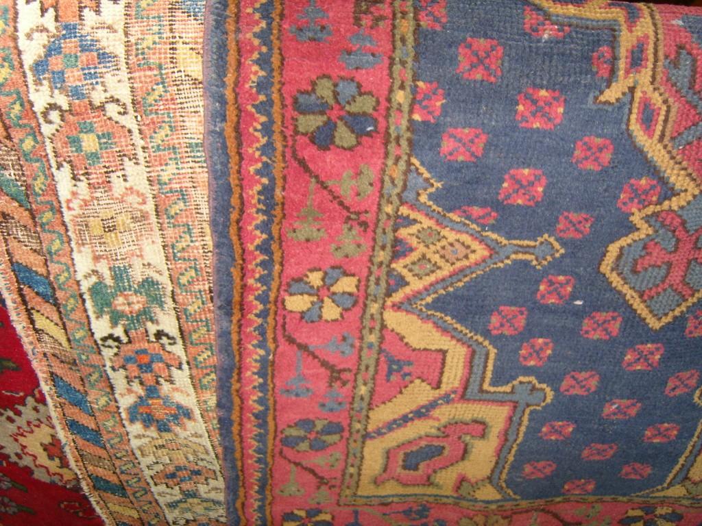 Appraisal: A blue ground eastern wool rug with pink gold and