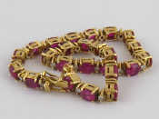 Appraisal: A yellow metal tests carat gold ruby and diamond bracelet