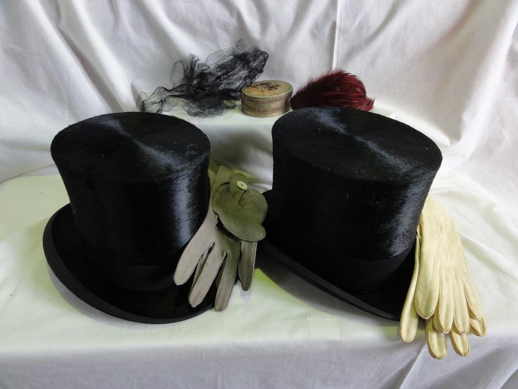 Appraisal: A silk top hat with two pairs of kid gloves