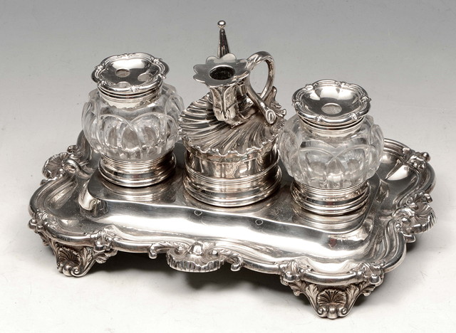 Appraisal: A WILLIAM IV SILVER DESK STAND rectangular and shaped base