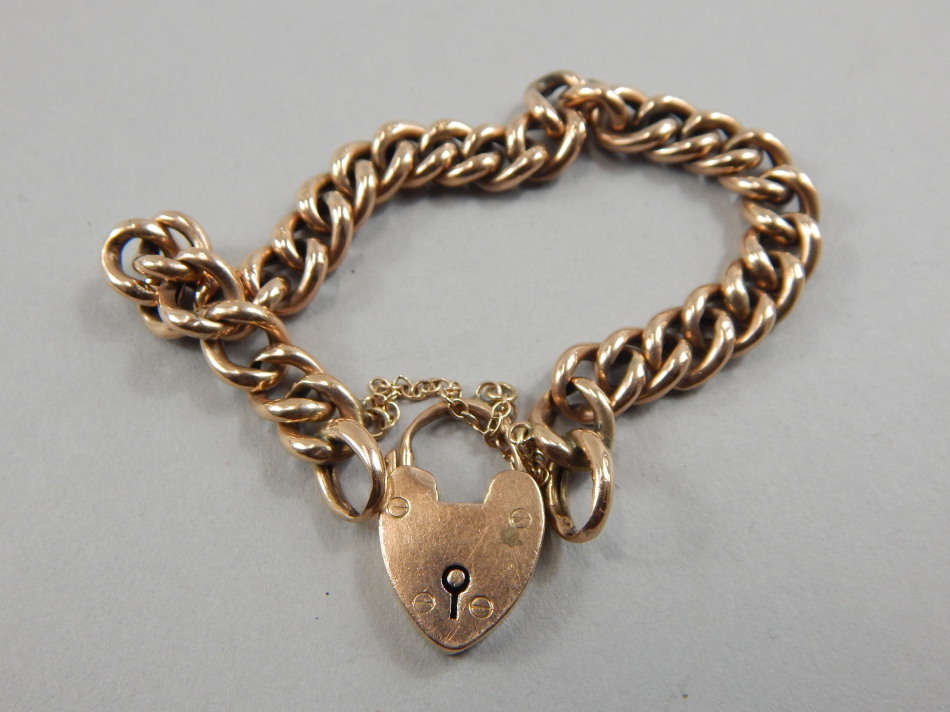 Appraisal: A gate bracelet with curb links and padlock yellow metal