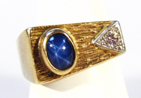 Appraisal: A chunky dress ring set with small polished blue oval