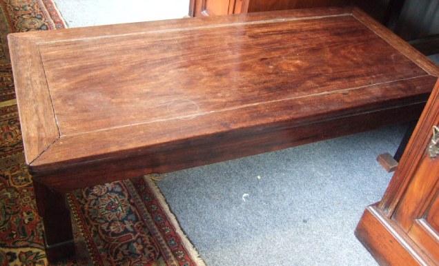 Appraisal: A Chinese hardwood low coffee table with rectangular top and