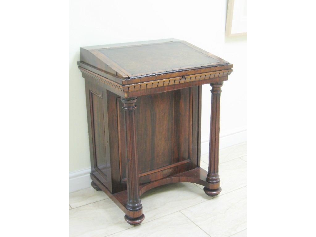 Appraisal: An early th Century rosewood Davenport with hinged cover on