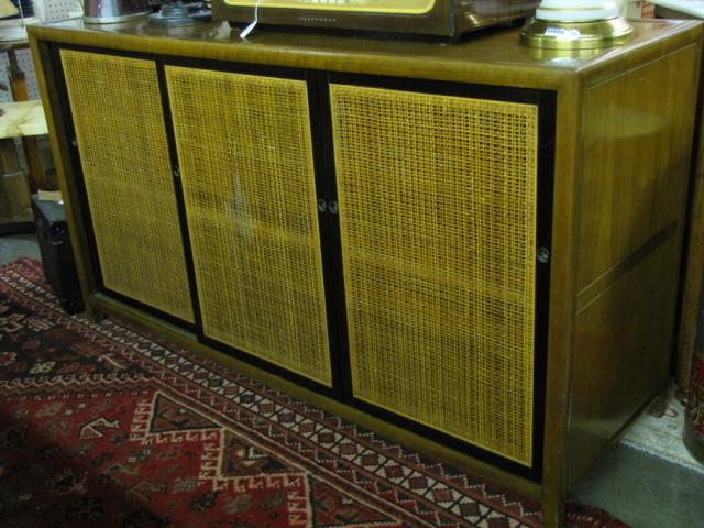 Appraisal: Mid century Baker commode console with three sliding doors with